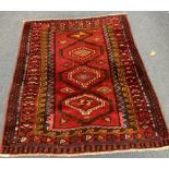 A Caucasian style red ground rug, 204 x 160cm