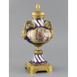 A late 19th century French ormolu mounted Sevres style porcelain cassolette, painted with panels