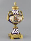 A late 19th century French ormolu mounted Sevres style porcelain cassolette, painted with panels