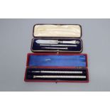 A cased late Victorian silver spiral decorated pen and a similar sterling pencil, 15.2cm and a cased