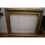 A large 19th century giltwood and gesso picture frame with oak leaf moulding, aperture 85 x 110cm,