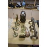 A Dutch brass candle sconce, a pair of Victorian Arts & Crafts brass fire dogs, a lantern clock,