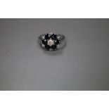 An 18ct, sapphire and diamond set cluster ring, size K, gross 4 grams.CONDITION: There is a slight