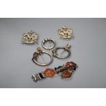 Three Scottish white metal torqs, a silver buckle and a white metal and Scottish hardstone set