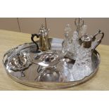 A quantity of plated wares including a seven bottle cruet, a claret jug and a large oval tray,