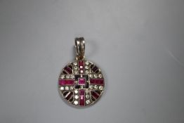 An early 20th century white and yellow metal, ruby and diamond set pierced circular pendant, 20mm,
