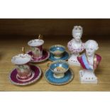 A pair of German porcelain busts of Louis XVI and Marie Antoinette, tallest 16cm, and four cups