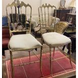 A pair of brass side chairs with padded seats