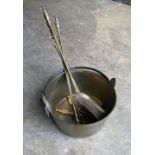 A Victorian brass preserve pan, diameter 36cm, a set of brass fire implements and a pair of fire