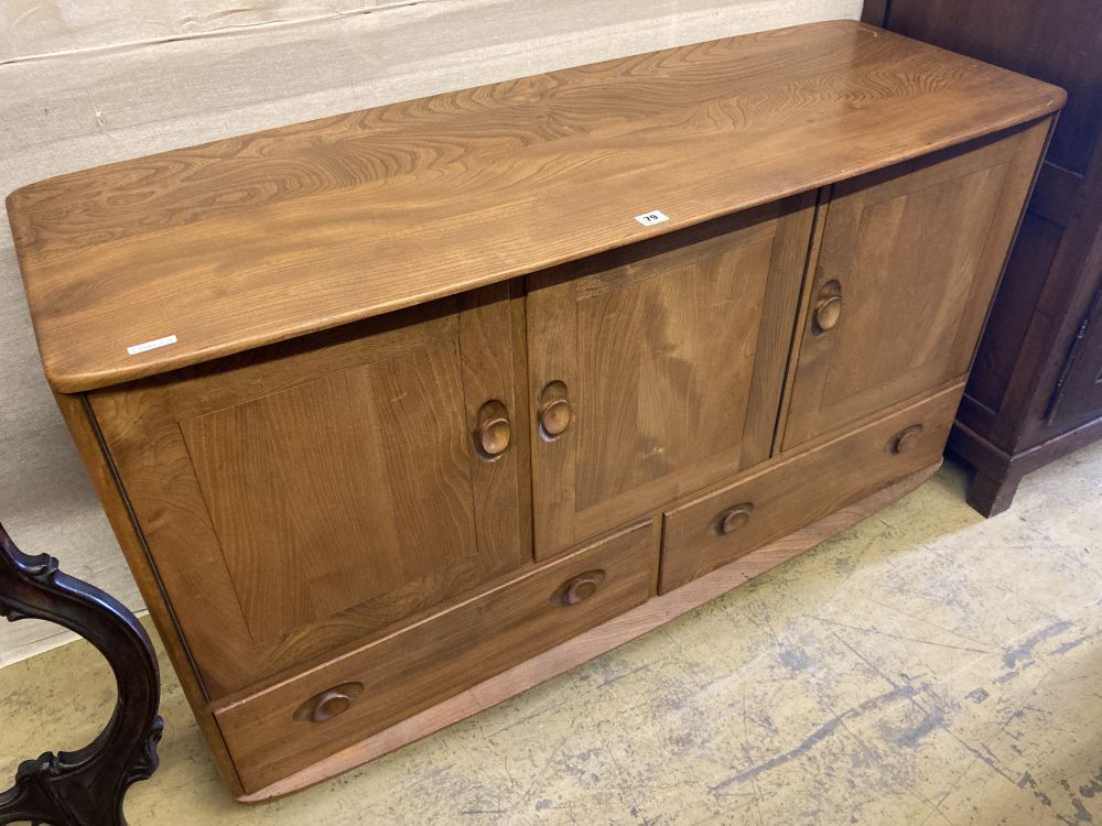 An Ercol light elm three door sideboard, width 130cm, depth 48cm, height 76cm