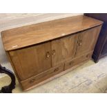 An Ercol light elm three door sideboard, width 130cm, depth 48cm, height 76cm