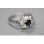 A modern 18ct white gold, sapphire and diamond cluster ring, size M, gross 3 grams.CONDITION: Good