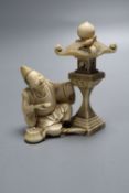 A fine 19th century Japanese ivory figure of a priest by a garden lantern, two character signature