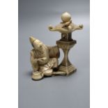 A fine 19th century Japanese ivory figure of a priest by a garden lantern, two character signature