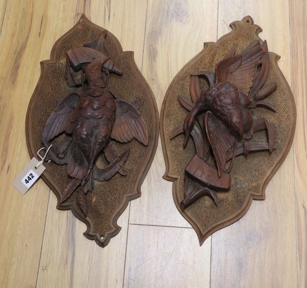 A pair of 19th century Black Forest carved walnut plaques depicting game birds