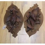 A pair of 19th century Black Forest carved walnut plaques depicting game birds