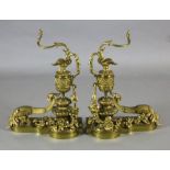 A pair of Louis XVI style ormolu chenets, modelled as urns mounted with scrolling floral foliage,