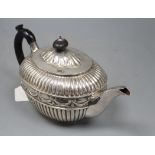 A Victorian fluted silver oval teapot by William Hunter, London, 1886, gross 20.5oz, with engraved