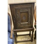 An 18th century design carved oak spice cabinet on associated stand (incorporates old timber), width