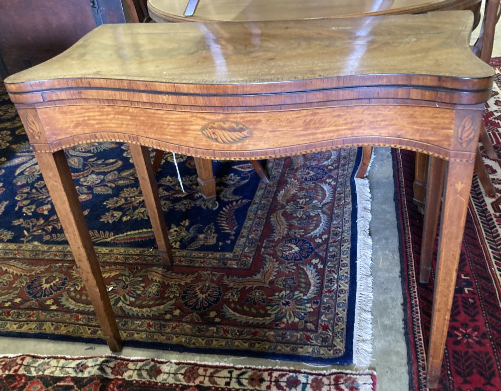 A George III inlaid satinwood folding-top serpentine card table, width 88cm, depth 45cm, height