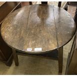 An 18th / 19th century circular oak cricket table, 70cm diameter, height 63cm