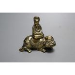 A small 18th century Chinese bronze group of Guanyin seated on a recumbent mythical beast, height