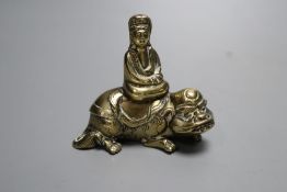 A small 18th century Chinese bronze group of Guanyin seated on a recumbent mythical beast, height