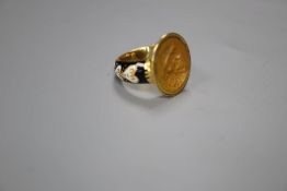 An antique yellow metal, black and white enamel and intaglio hardstone set signet ring, carved