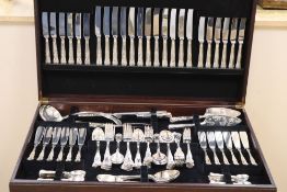 A canteen of King's pattern cutlery in a mahogany free-standing canteen.