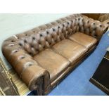 A Victorian style buttoned brown leather three seater Chesterfield settee, width 200cm, depth