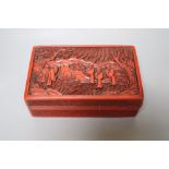 A Chinese cinnabar lacquer box, Qing Dynasty, the cover carved with deity, width 18cm, some