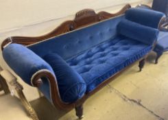 An early Victorian mahogany scroll arm settee upholstered in blue velvet, width 200cm, depth 56cm,
