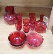 A quantity of 19th century cranberry glass including two jugs and eight glasses, six finger bowls,