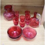 A quantity of 19th century cranberry glass including two jugs and eight glasses, six finger bowls,