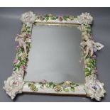 A 19th century Continental cherub and floral encrusted porcelain dressing mirror, height 43cm