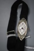 A lady's late 1920's 18ct white gold and diamond set manual wind cocktail watch, on a fabric