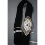 A lady's late 1920's 18ct white gold and diamond set manual wind cocktail watch, on a fabric