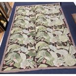 A needlework rug, worked with a water lily design, 264 x 180cm