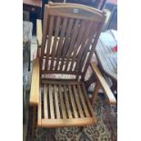 Six teak folding garden armchairs with cushions, an octagonal weathered teak folding garden table,