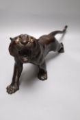 A Japanese Meiji bronze model of a tiger, signed, length 40cm