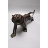 A Japanese Meiji bronze model of a tiger, signed, length 40cm