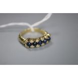 A modern 750 yellow metal, cabochon sapphire and diamond set half hoop dress ring, with spiral twist