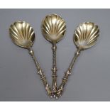 A set of three late Victorian silver fancy serving spoons with figural terminals, Goldsmiths &