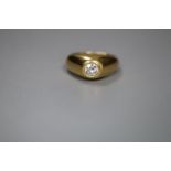 A modern 18ct gold and gypsy set solitaire diamond ring, size P, gross 10 grams, the stone