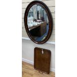 A 1920's rectangular oak tea tray, 64 x 43cm and a faux tortoiseshell oval mirror