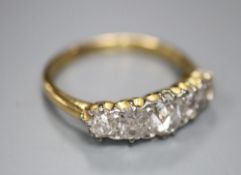 An 18ct gold and diamond five-stone ring, size L/M, gross 3 grams.CONDITION: The largest stone and