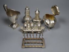 Small silver including a George V tea caddy, toastrack, cream jug, two pepperettes and an Art Deco