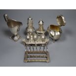 Small silver including a George V tea caddy, toastrack, cream jug, two pepperettes and an Art Deco