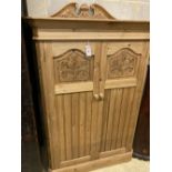 A Victorian style carved pine two door dwarf cabinet, width 98cm, depth 56cm, height 150cm