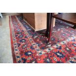 A North West Persian style red and blue ground carpet, 300 x 190cm